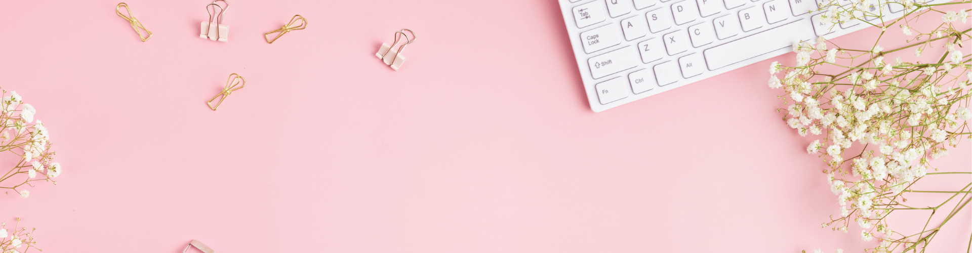 Pink work desk with keyboard.